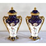 COALPORT; a pair of gilt heightend blue and white twin handled vases and covers, the fronts