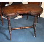 A late Victorian figured walnut kidney shaped occasional table, raised on twin fluted and carved end