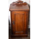A late Victorian walnut pot cupboard with raised back above single panel cupboard door enclosing a
