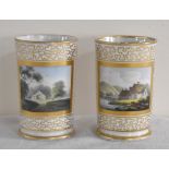 CHAMBERLAINS WORCESTER; a pair of spill vases, each painted with a vignette panel within a gilt