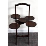 'THE MONOPLANE'; a patent mahogany folding cake stand set with dished platforms, height 78cm.