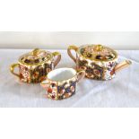 DAVENPORT; a miniature three piece tea set comprising teapot, twin handled sugar bowl and cover, and