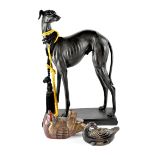 A large wooden carved figure of a greyhound on a rectangular plinth, height 60cm, length 40cm,