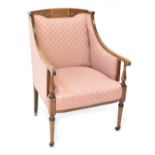 An Edwardian inlaid mahogany enclosed armchair, upholstered in pink,