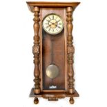 A Victorian walnut spring-driven Vienna wall clock, the dial set with Roman numerals,