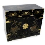 A contemporary black lacquered Oriental cupboard with overall peony,