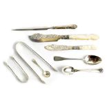 A selection of hallmarked silver items to include two pairs of sugar tongs,