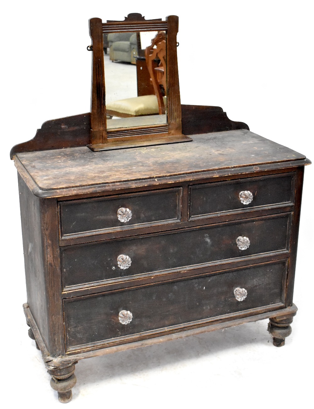 An early 19th century rustic pine chest of two short over two long drawers,