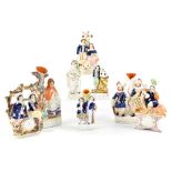 A group of late 19th/early 20th century Staffordshire figures to include spill vases,