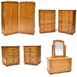 An extensive pine bedroom suite comprising four two-door wardrobes, two chests of six long drawers,