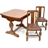 An early 20th century oak dining suite comprising a draw leaf table,