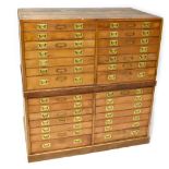 An early 20th century stained pine museum-style chest of collectors' display drawers,