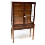 A modern mahogany veneered glazed display cabinet with two inner glass shelves,