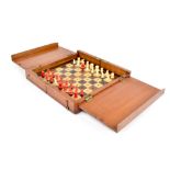 A cased travelling chess set with inlaid board and stained bone chess pieces, box with brass hinges.