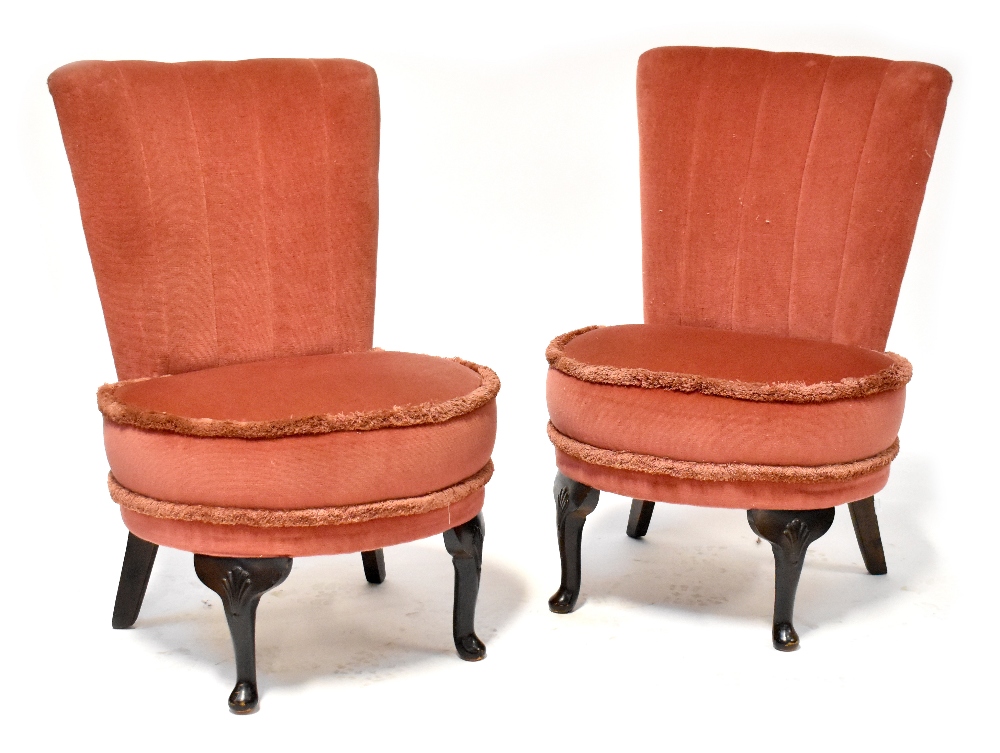 A pair of 1940s low side chairs raised on cabriole legs (2).