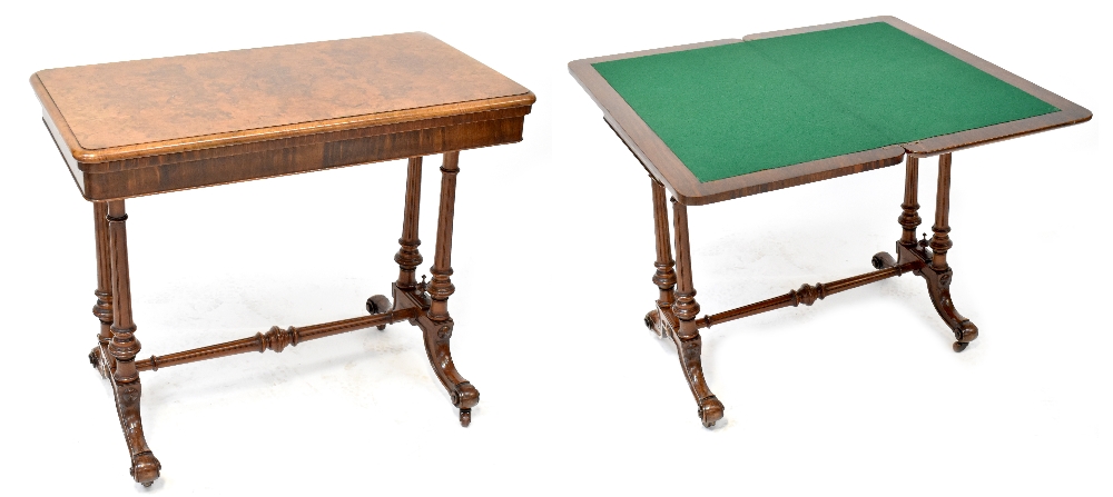 A Victorian burr walnut card table on twin turned pedestal base, united by stretcher,