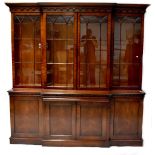 A reproduction mahogany breakfront bookcase,