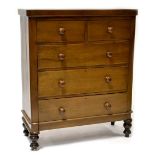 An early 20th century walnut chest of two-over-three drawers raised on turned feet, height 120cm,