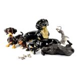 Various Dachshunds figures to include two large Winstanley examples with glass eyes,