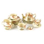 A Japanese Satsuma part tea service comprising teapot, four plates, five saucers,