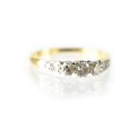 A ladies' 18ct gold diamond eternity ring, with three small platinum claw-set diamonds,
