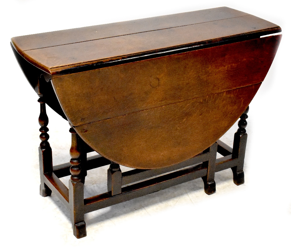 A late 17th/early 18th century oak oval gateleg table with end drawer,