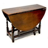 A late 17th/early 18th century oak oval gateleg table with end drawer,
