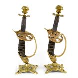 A pair of candlesticks fashioned from WWI era German Imperial Army cavalry sword handles,