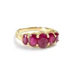 A yellow metal dress ring set with five graduated rubies, size P, approx 2.7g.