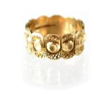 A hallmarked 9ct gold band ring with a band of flower heads, size N, approx 3.8g.