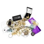 A quantity of vintage and contemporary costume jewellery to include yellow metal link necklaces,