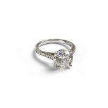 An 18ct white gold round brilliant cut diamond solitaire ring with sixteen round brilliant cut