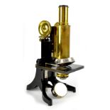 A cased J Swift & Son brass and lacquered metal microscope, with three lenses, stamped 2/3in,