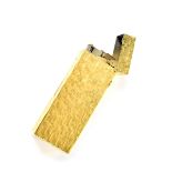 A 1970s vintage gas fill Dunhill T9 model gold plated lighter, the textured body and side wheel,