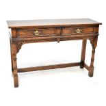 A Titchmarsh & Goodwin reproduction oak two-drawer dresser base with carved apron,