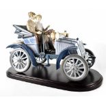 A Lladró limited edition figure group 5884 'Motoring in Style', depicting a couple in a vintage car,
