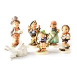 Five Goebel/Hummel figures to include Alpine walkers, boy in apple tree, carol singer,