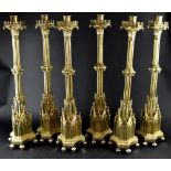 A fine set of six substantial ecclesiastical Gothic Revival gilt brass candlesticks in the manner