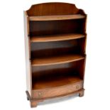 A reproduction mahogany bow-fronted floor standing bookcase with galleried top and four shelves