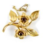 A 9ct yellow gold flower spray brooch, the centre of each flower set with garnets, approx 9.5g.