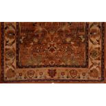 A modern brown ground rug with a central square of Chinoiserie flowers and fauna surrounded by a