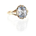 A 9ct gold dress ring with claw-set blue stone, possibly spinel, size N, approx 2.3g.