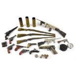 Various collectible miniature guns including brass shotguns,