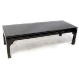 A contemporary dark stained Oriental-style coffee table with curved ornamental frieze to block