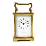 Mappin & Webb; a brass-cased carriage clock, the enamelled dial set with Roman numerals, signed,