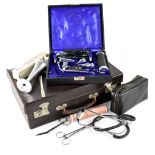A small brown attaché case containing various doctor's equipment to include a stethoscope,