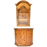 A reproduction painted pine cabinet on stand with single glazed door above central door,