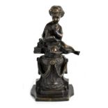 A late 19th century bronze figure of a seated child in Classical dress reading from a book,