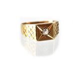 A 9ct yellow gold gentlemen's signet ring with starburst set white stone, size P, approx 2.9g.
