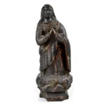 A 17th century or earlier carved lime wood figure depicting a religious figure, possibly Mary,